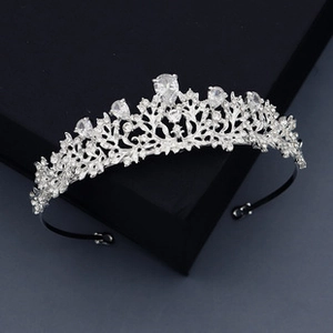 Detail of silver bridal tiara with sparkling rhinestones and leaf-shaped alloy patterns
