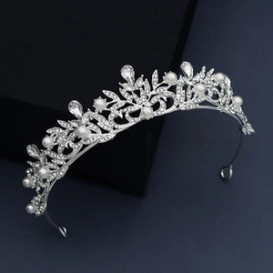 Detailed view of silver bridal crown with white pearls and sparkling rhinestones