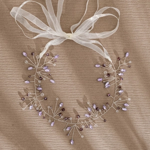 Detail of purple crystal bridal hair vine with silver wire and white organza ribbon