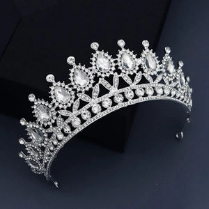 Close-up of elegant bridal headband featuring teardrop rhinestones and silver alloy leaves