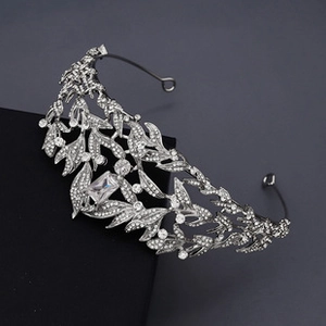 Detailed close-up of a bridal silver leaf tiara with sparkling rhinestones and crystal