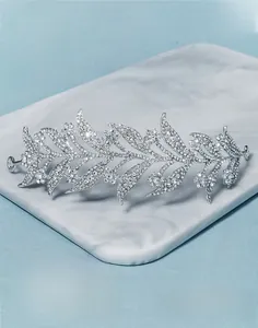 Macro detail of silver leaf bridal crown with sparkling rhinestones and alloy vine design