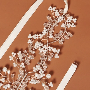 Detail of bridal headband with silver wire, white pearls, crystals, and silk ribbon