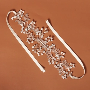 Detailed macro view of handmade bridal headband with white pearls and glass beads