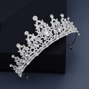 Detailed macro view of sparkling silver rhinestone crown with pear-cut crystal leaf patterns