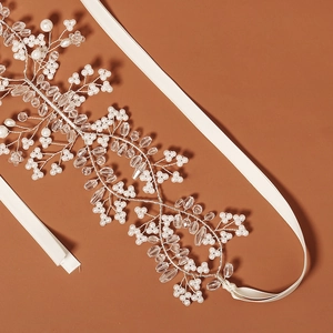Detail showing handmade beadwork with pearls and crystals on a bridal headband