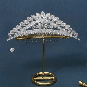 Detail of elegant fan-shaped bridal tiara comb with radiant silver rhinestones and gold base