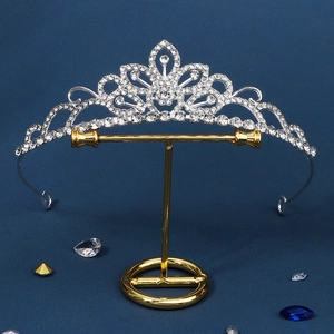 Detail view of silver bridal crown featuring sparkling rhinestones and floral heart designs