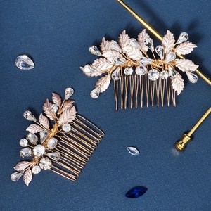 Detail of handmade leaf hair combs with sparkling rhinestones on a blue surface
