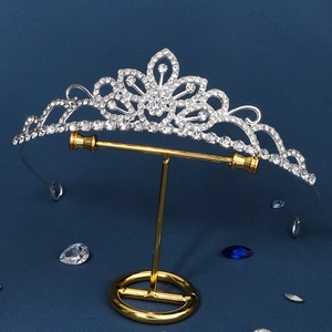 Elegant bridal silver rhinestone tiara crown with pear-cut crystals on gold display stand