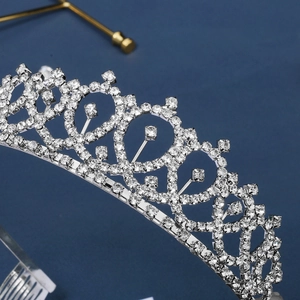 Elegant silver bridal crown with heart-shaped scrolls and sparkling rhinestones