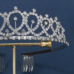Macro shot of silver bridal crown featuring heart-shaped cutouts and shimmering rhinestones