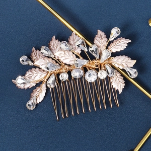 Macro shot of gold leaf bridal hair comb with water-drop rhinestones for wedding