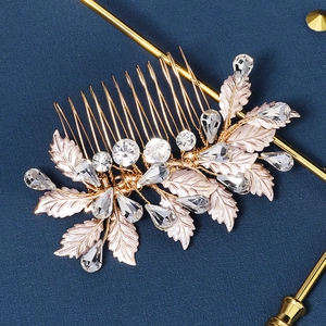 Detailed macro view of golden metal leaves and sparkling rhinestones on the bridal hair comb