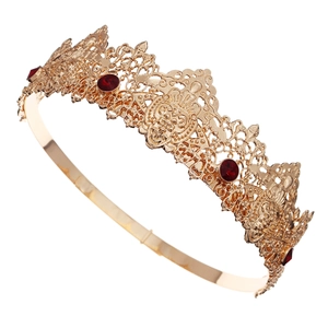 Detailed close-up of Baroque gold crown featuring hollow patterns and red gemstones