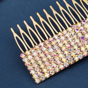 Close-up of rainbow crystal rhinestones on a gold-plated bridal hair comb detail