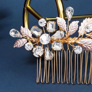 Macro detail of handmade bridal hair comb with gold leaves and sparkling crystals