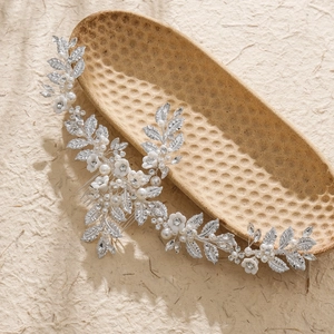 Silver bridal hair comb with clay flowers, crystals, and pearls on leaf branches
