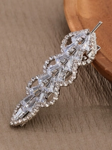 Détail macro d'une barrette en forme de feuille avec cristaux étincelants et base argentée