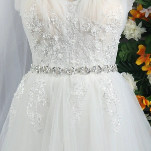 Close-up of luxury bridal belt featuring marquise rhinestones and delicate floral lace detail