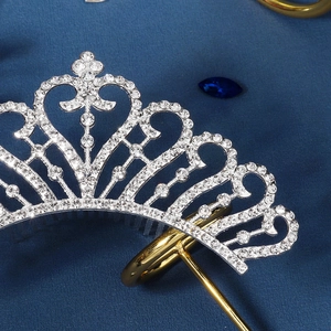 Detailed close-up of a silver bridal tiara featuring intricate scrolls and sparkling rhinestones