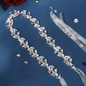 Close-up of luxury bridal belt with marquise rhinestones and white organza ribbons