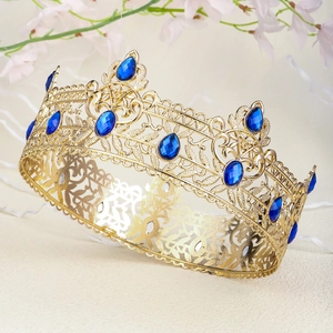 Detailed close-up of Baroque gold crown featuring blue gemstones and intricate metal hollow work
