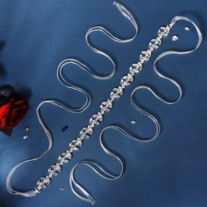 Close-up of luxury bridal belt featuring marquise rhinestones and white ribbon ties
