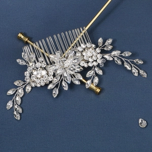 Detail of silver bridal hair comb with marquise rhinestones and golden styling pins