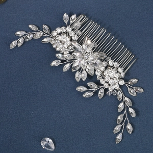 Close-up of silver wire bridal hair comb with marquise rhinestones and crystal flower details