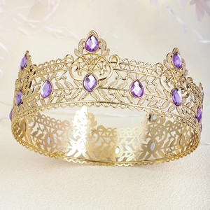 Macro shot of baroque gold crown with intricate hollow carvings and purple gemstones