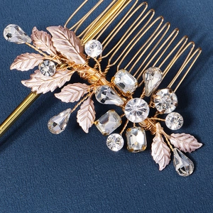 Elegant gold hair comb with metallic leaves and sparkling crystals for bridal styling