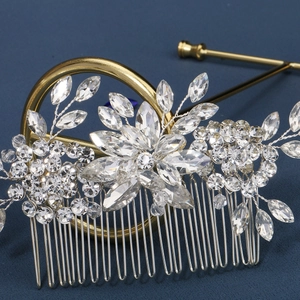 Detailed view of marquise rhinestone flower hair comb on a gold stand for bridal styling