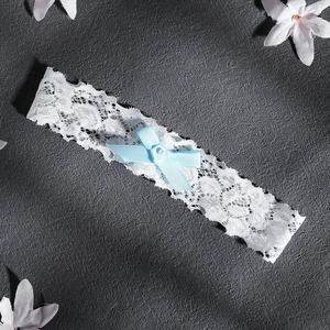 Elegant bridal lace garter with light blue bow and pearl accent for wedding accessories