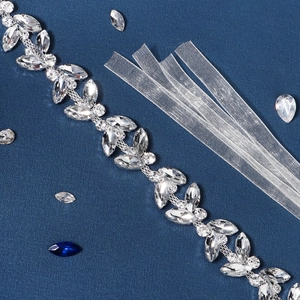 Close-up of luxury marquise rhinestone bridal belt with elegant white organza ribbon