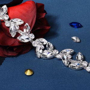 Macro detail of luxury marquise rhinestone bridal belt with silver alloy setting and crystals