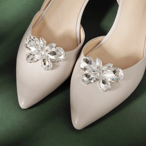 Close-up of sparkling crystal flower shoe clip on elegant pointed-toe high heel pumps