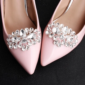 Detail view of sparkling crystal sunflower shoe clips on pink pointed toe stiletto heels