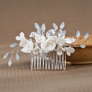 Detail of silver bridal hair comb with handmade ceramic flowers and blue crystal beads