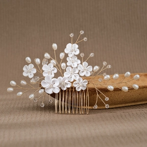 Detailed view of handmade ceramic flower bridal hair comb with pearls and gold wire