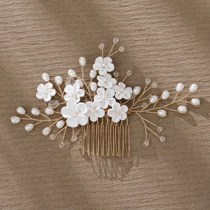 Detailed view of handmade bridal hair comb with ceramic flowers and crystal pearls