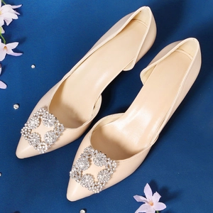 Elegant pointed toe bridal shoes with square crystal buckles on navy blue background