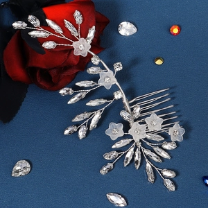 Detail of silver bridal hair comb with frosted white acrylic flowers and marquise rhinestones