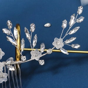 Macro detail of silver floral hair comb with marquise rhinestones and acrylic petals