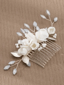 Detail of bridal hair comb with white handmade flowers, crystals and silver metal leaves