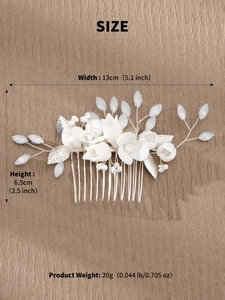 Detail view of handmade bridal hair comb with ceramic flowers and frosted leaves on leather