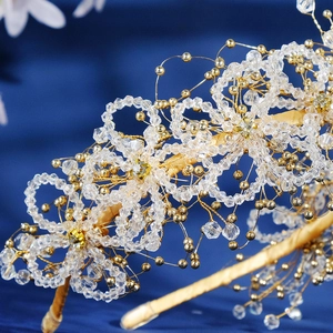 Exquisite beaded bridal headband featuring golden flowers and clear crystal accents
