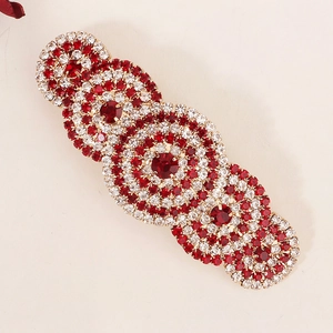 Exotic gold alloy hair clip with red and white sparkling rhinestones in a circular pattern