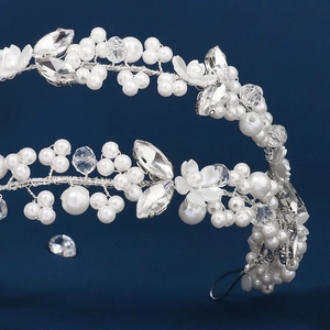 Detailed macro view of bridal silver wire headband with pearls and crystal flowers