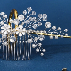 Close-up of handmade bridal hair comb with white flowers, crystals and pearls details